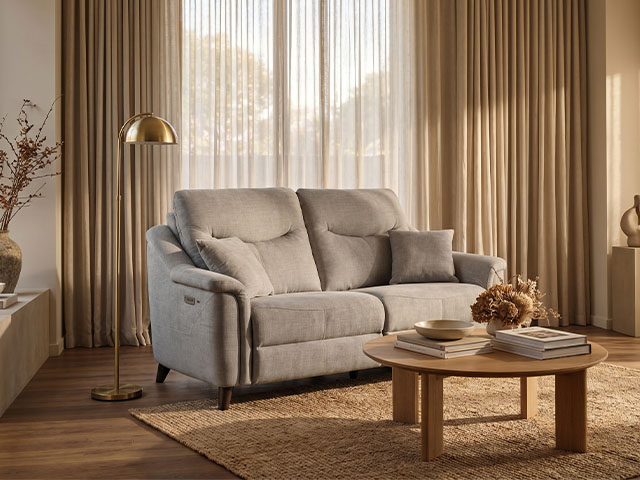 Olive recliner armchair beside a wooden sideboard in a downsizer's living space