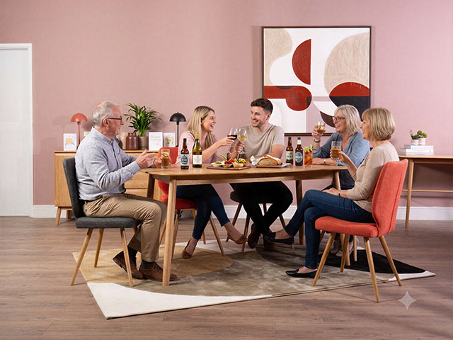 Round dining table and grey corner sofa in a bright first-home living room