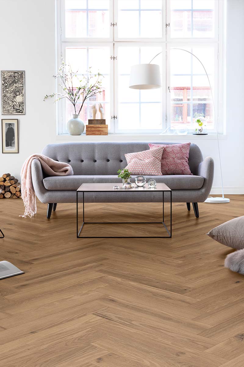 Herringbone flooring in an open-plan living room